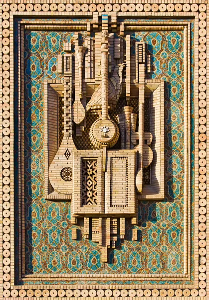 Mosaik av musikinstrument gjort av tegel Stockbild