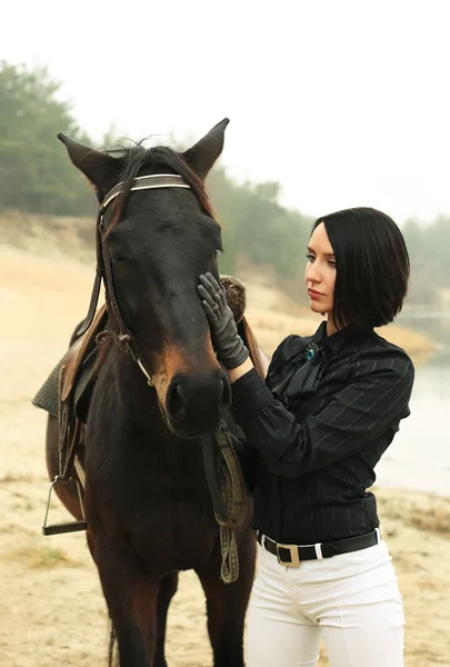 stock image Woman with a horse near river