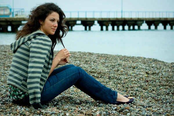 stock image Woman on the sea shore with breakwater
