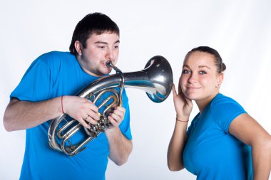 Woman is listening music of French horn clipart