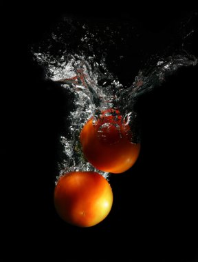 Isolated red tomatoes in water clipart