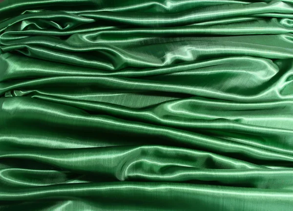 エレガントなグリーン シルクの滑らかな背景として使用することができます。 — ストック写真