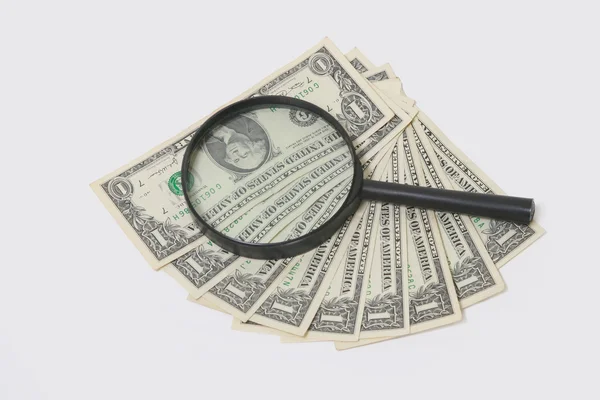 Dollar through magnifying glass — Stock Photo, Image