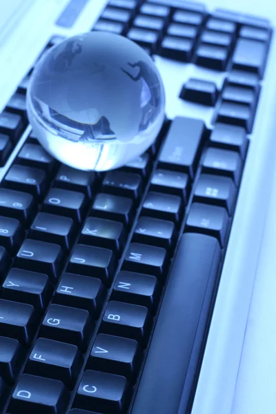 The glass globe on the keyboard — Stock Photo, Image