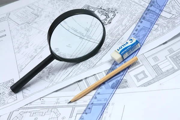 Building projects with architect drawing and protective tools — Stock Photo, Image