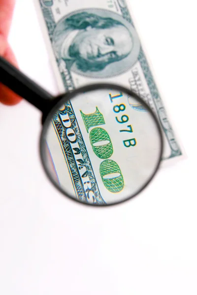 Kind of dollar through magnifying glass — Stock Photo, Image