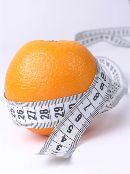 Orange embraced by a measuring tape — Stock Photo, Image