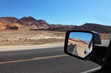 The road is reflected in the car mirror clipart