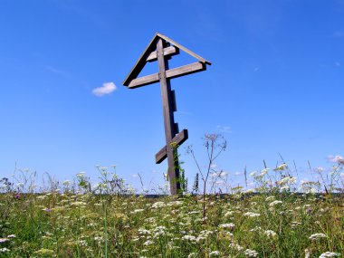 Solitary grave cross on field clipart