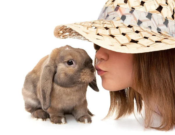 Girl in a straw hat kisses dwarf rabbit. — Stock Photo, Image