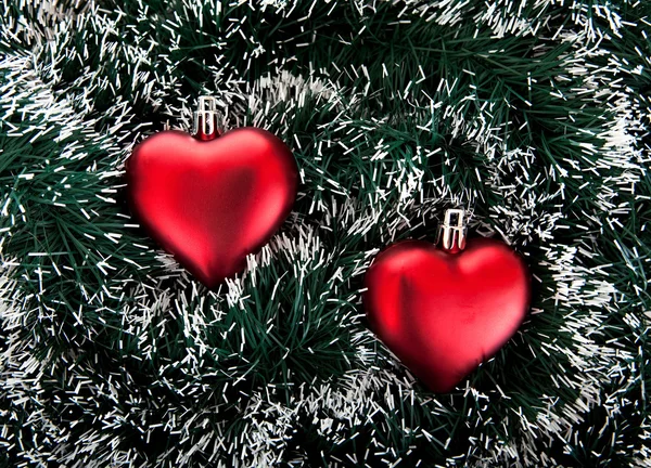 Toy in the shape of the heart and tinsel. — Stock Photo, Image