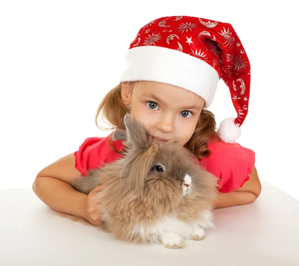 Criança no chapéu de Ano Novo com um coelho . — Fotografia de Stock