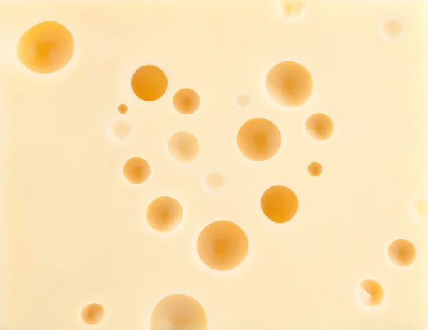 Käse Hintergrund mit herzförmigen Löchern — Stockfoto