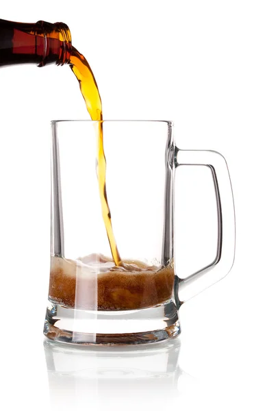 Beer is pouring into a glass from bottle — Stock Photo, Image