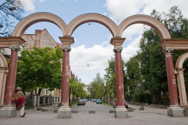 Arch on a green city street clipart