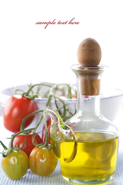 Olive oil and branch of organic tomatoes — Stock Photo, Image