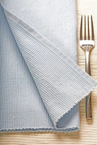 Fork on blue napkin — Stock Photo, Image