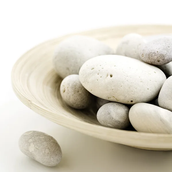 Pebbles in bamboo bowl — Stock Photo, Image