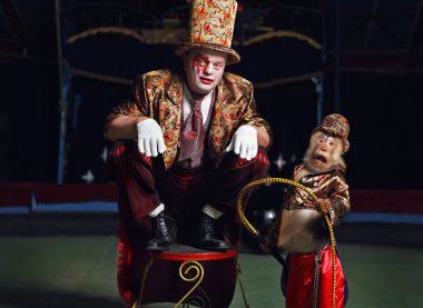 Circus clown with a monkey. clipart