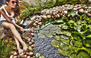 Happy young female with Garden streamlet relaxing near the pond. clipart