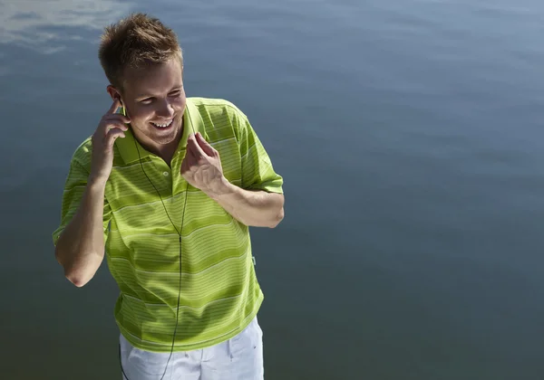 Cheerful guy in a green vest. — Stock Photo, Image