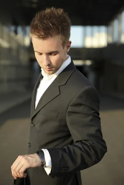 Businessman looking at watch Stock Photo