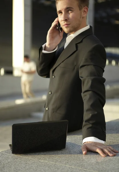Businessman portrait with laptop and mobile phone — Stock Photo, Image
