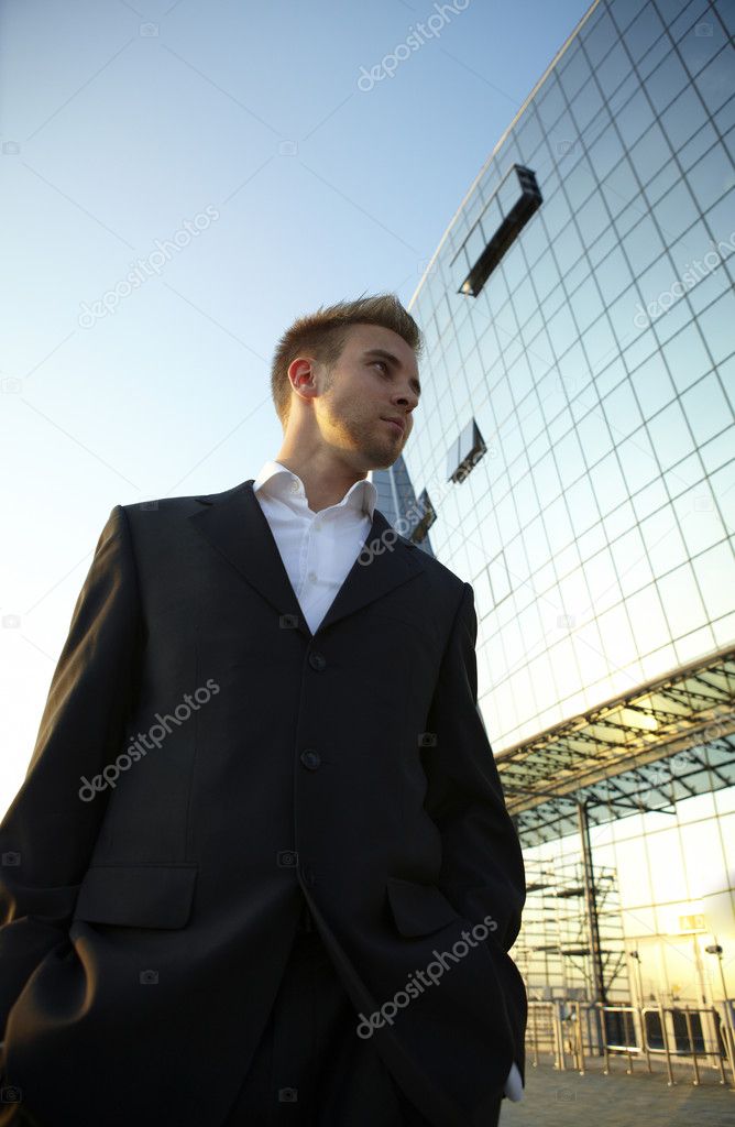Young businessman portrait against urban background