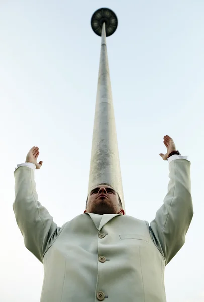Photo verticale de l'homme contre une colonne partant dans le ciel — Photo