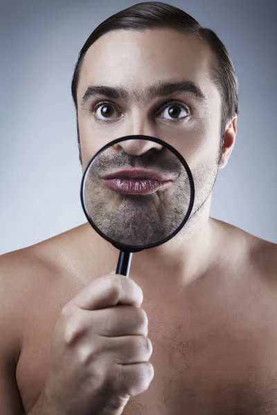 Funny portrait of a adult man with a magnifying glass. — Stock Photo, Image