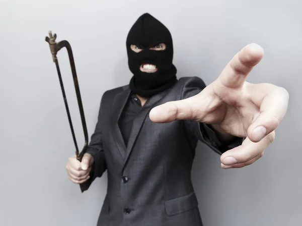 Malvagio criminale che indossa maschera militare isolata su sfondo grigio . — Foto Stock