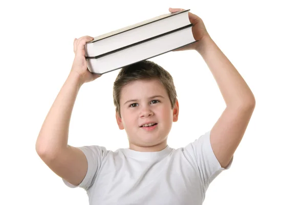 Heureux garçon tient quelques livres au-dessus de la tête — Photo