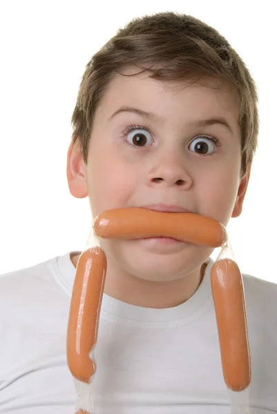 惊讶的男孩拿着香肠嘴里 — Φωτογραφία Αρχείου
