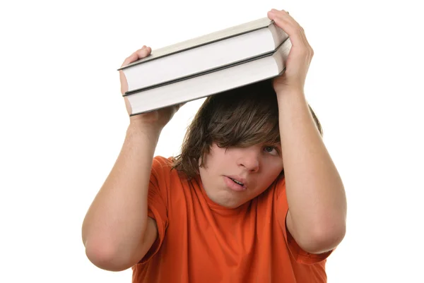 Teenager tiene alcuni libri sopra la testa — Foto Stock