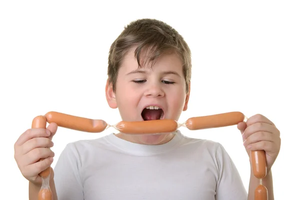 Niño con apetito muerde salchichas —  Fotos de Stock