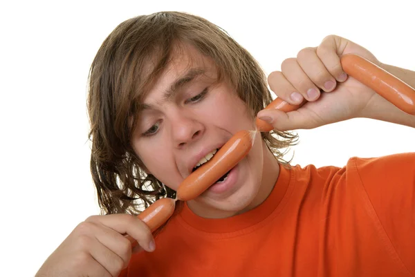 Teenager with appetite bites sausages — Stock Photo, Image