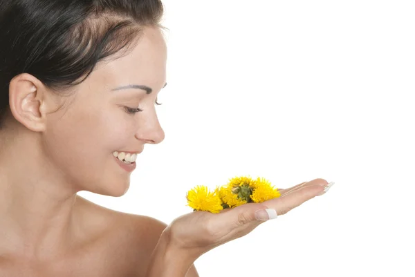 Woman holds yellow flowers on palm — Stock Photo, Image
