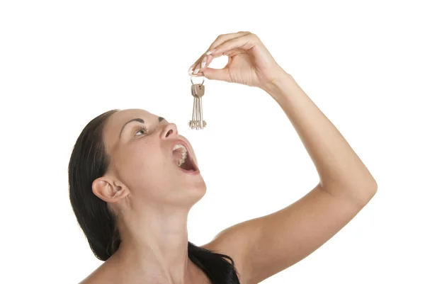 Young woman swallows of keys — Stock Photo, Image