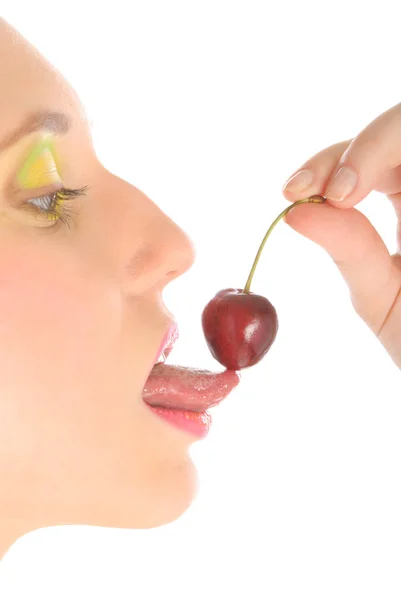 Woman with make-up licks cherry — Stock Photo, Image