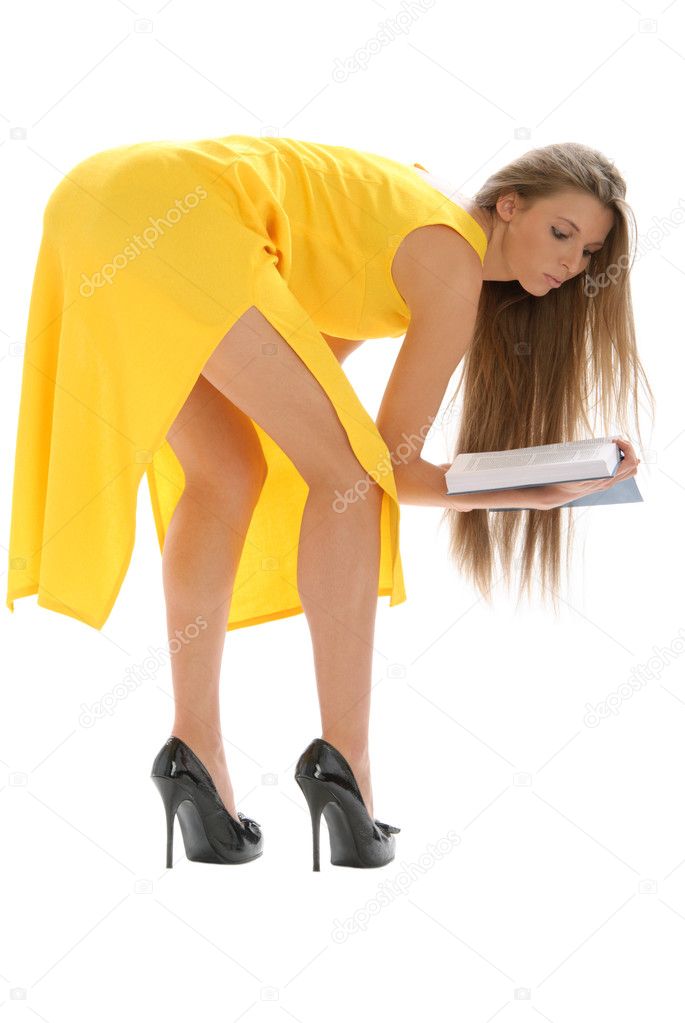 Young woman in yellow dress and with book