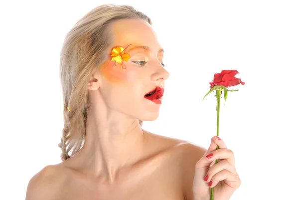 Young woman bites red flower — Stock Photo, Image