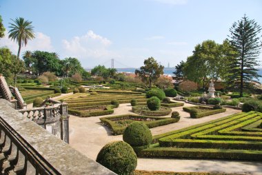 Enchanted Ajuda garden with April 25th bridge in Lisbon, Portugal clipart