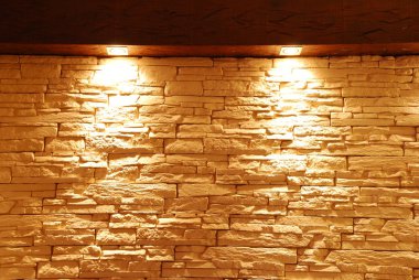Unshaped stone wall with spot lights clipart