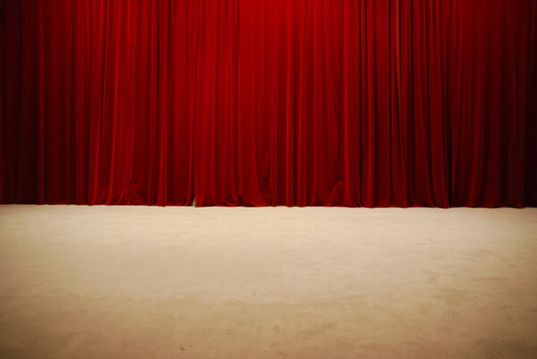 Red draped theater stage curtains
