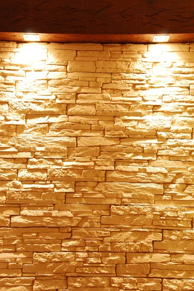 Unshaped stone wall with spot lights — Stock Photo, Image