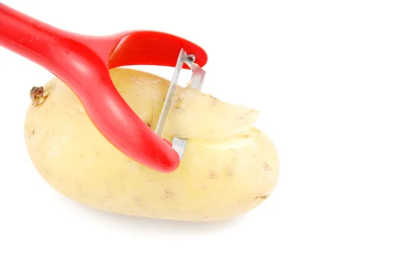 stock image Peeling a potato with peeler on white