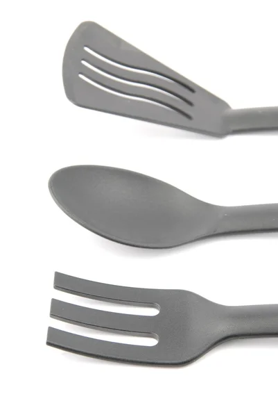 Black plastic kitchen utensil on white — Stock Photo, Image