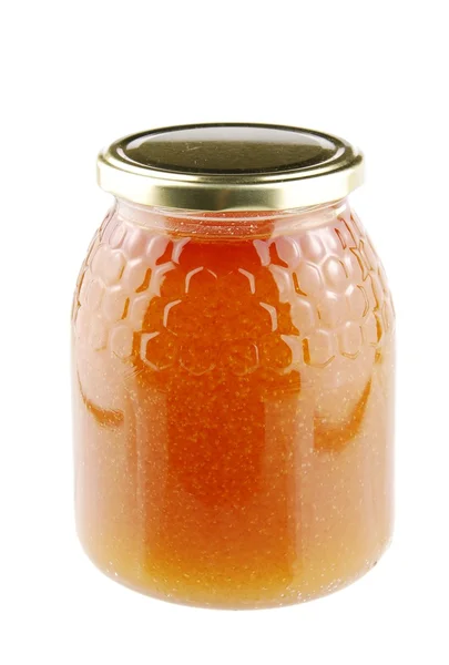 Huisgemaakte honing in een glazen pot op wit — Stockfoto