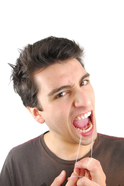 Homem a usar fio dental nos dentes (expressão NO ) — Fotografia de Stock