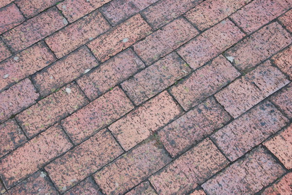 Diagonal and grungy brick tile pavement surface